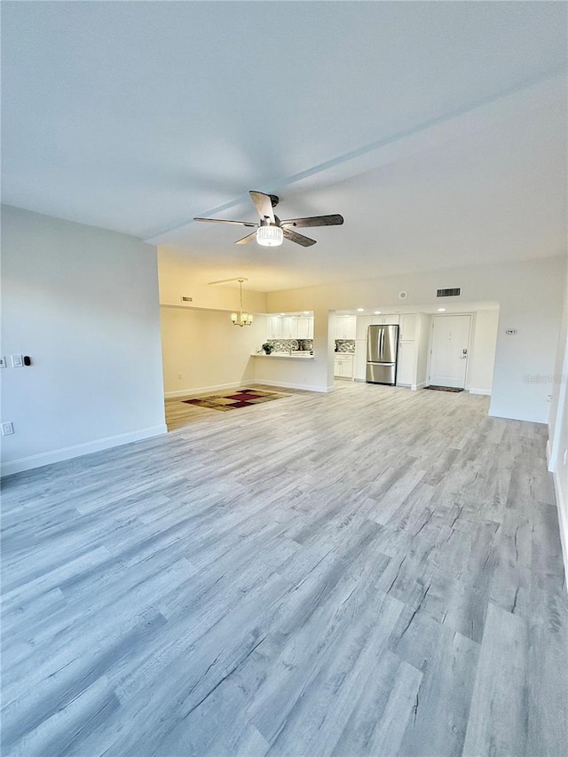 unfurnished living room with light wood-type flooring and ceiling fan