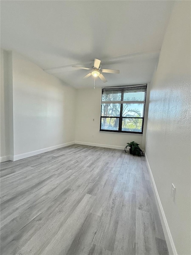 empty room with light hardwood / wood-style floors and ceiling fan