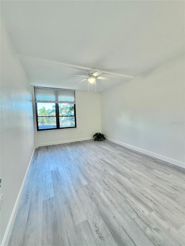 empty room with light hardwood / wood-style floors and ceiling fan