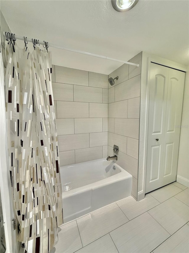 bathroom with shower / bath combination with curtain and tile patterned floors