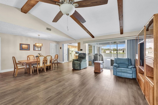 living room featuring dark hardwood / wood-style floors, lofted ceiling with beams, a textured ceiling, and ceiling fan with notable chandelier