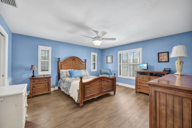 bedroom featuring dark hardwood / wood-style flooring and ceiling fan