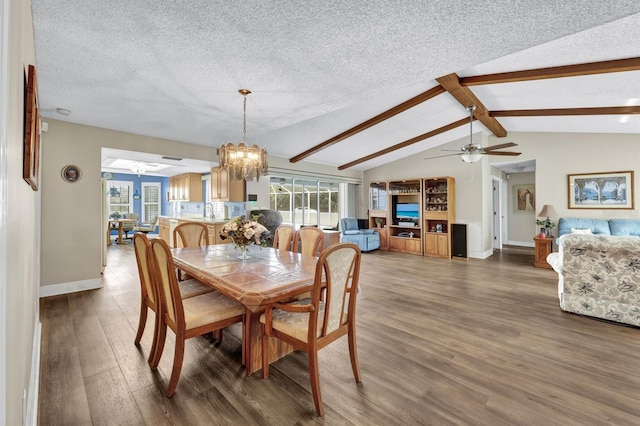 dining space with a textured ceiling, lofted ceiling with beams, ceiling fan with notable chandelier, and dark hardwood / wood-style flooring