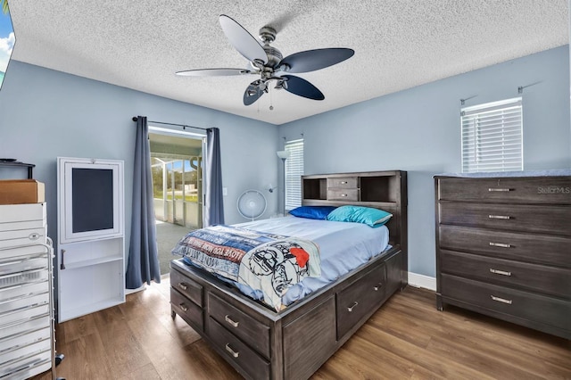 bedroom featuring ceiling fan, a textured ceiling, and hardwood / wood-style floors