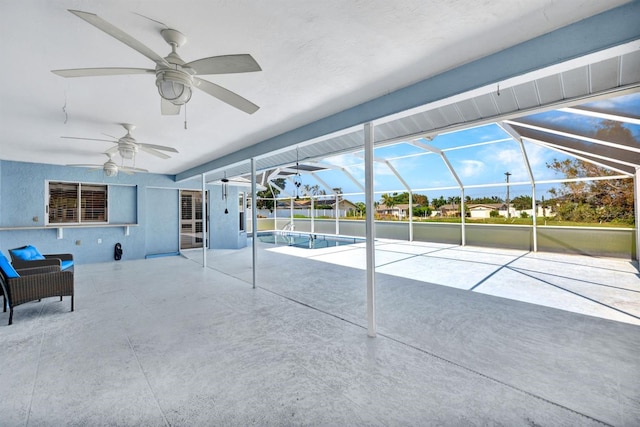 view of patio / terrace with ceiling fan and glass enclosure