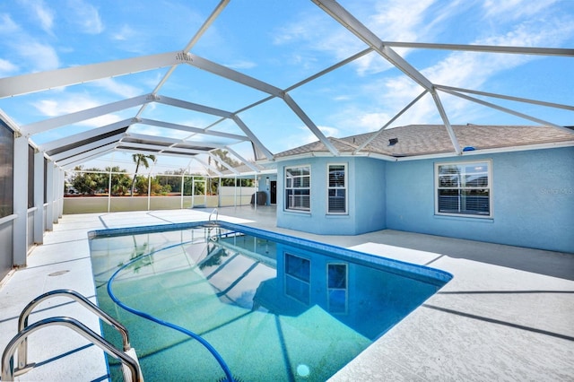 view of swimming pool with a patio and a lanai