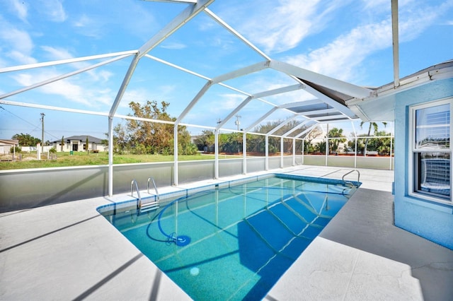 view of swimming pool featuring a patio area and a lanai