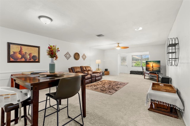 carpeted living room with ceiling fan