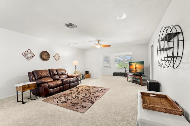 carpeted living room with ceiling fan