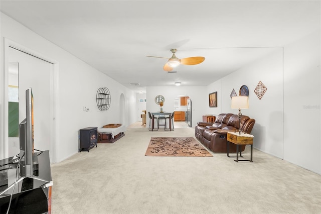 living room with light colored carpet and ceiling fan