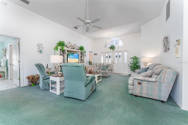 carpeted living room featuring french doors, ceiling fan, and a high ceiling