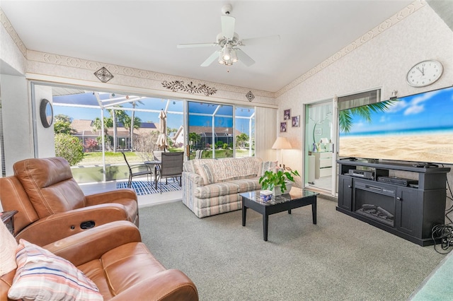 carpeted living room featuring vaulted ceiling, a healthy amount of sunlight, and ceiling fan