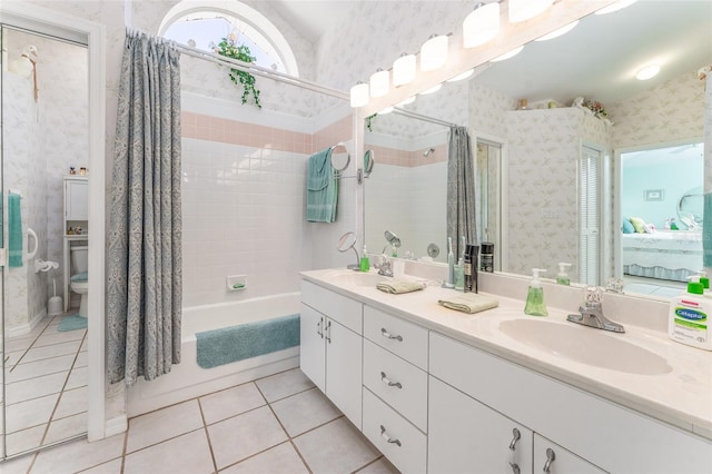 full bathroom featuring vanity, shower / tub combo with curtain, toilet, and tile patterned flooring