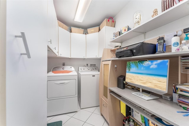 laundry area featuring cabinets, washer and dryer, and light tile patterned floors