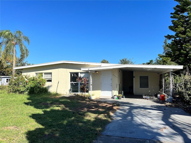 view of front of house with a carport and a front lawn