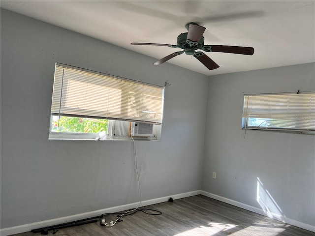 spare room with cooling unit, ceiling fan, and dark hardwood / wood-style flooring