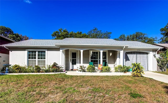 ranch-style house featuring a front lawn, a garage, and a porch