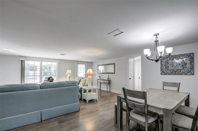 dining room with an inviting chandelier and wood-type flooring