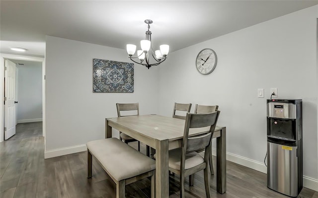 dining space featuring dark hardwood / wood-style flooring and a notable chandelier