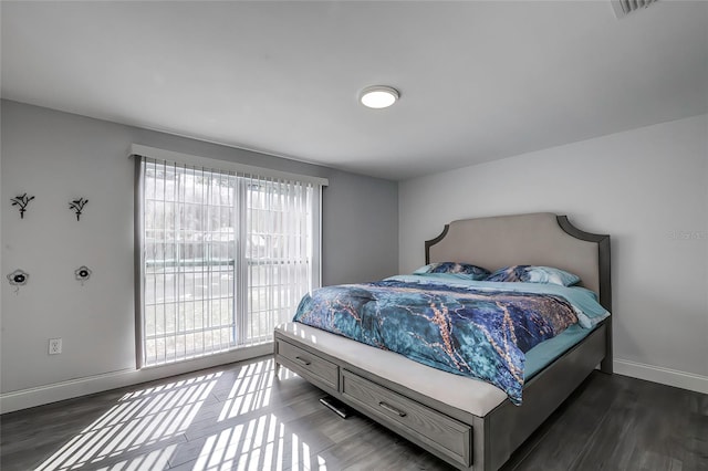 bedroom with dark wood-type flooring