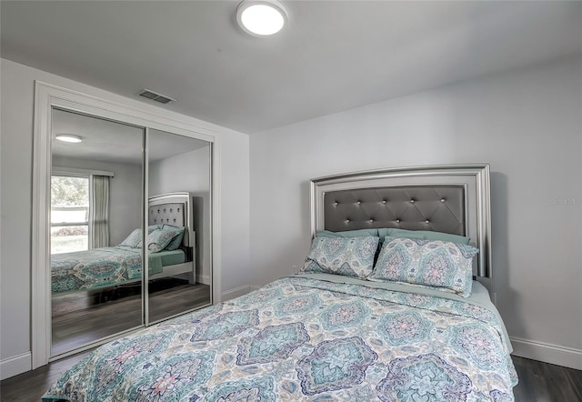 bedroom featuring dark hardwood / wood-style flooring and a closet