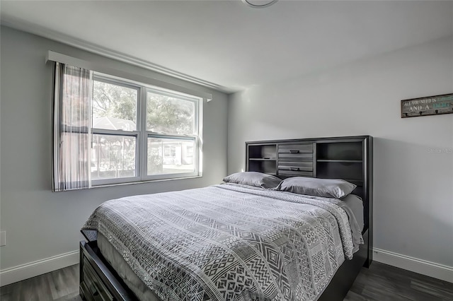 bedroom with dark hardwood / wood-style floors