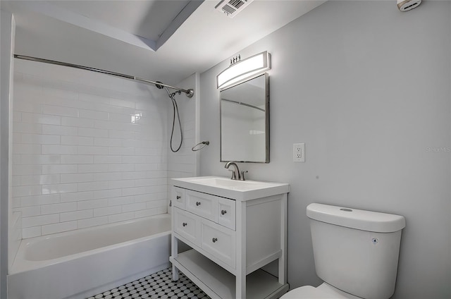 full bathroom with toilet, vanity, tiled shower / bath, and tile patterned floors