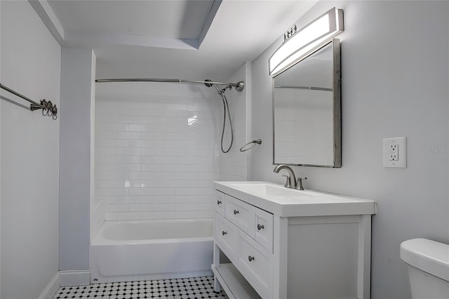 full bathroom featuring toilet, tiled shower / bath combo, and vanity