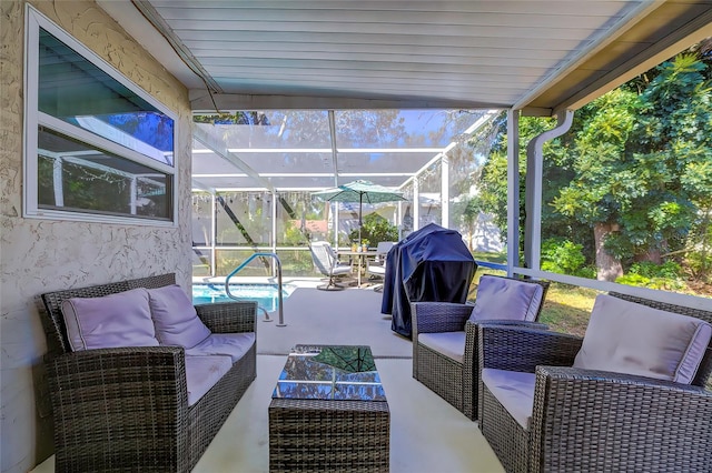 view of patio with outdoor lounge area, glass enclosure, and grilling area