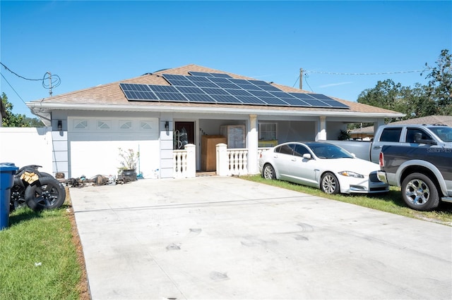 view of front of property featuring a garage and solar panels