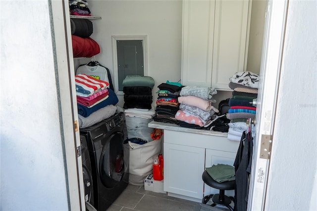 laundry room featuring tile patterned floors and cabinets