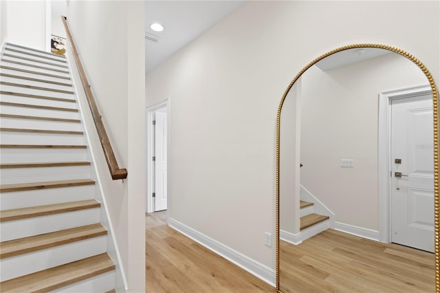 stairs with wood-type flooring