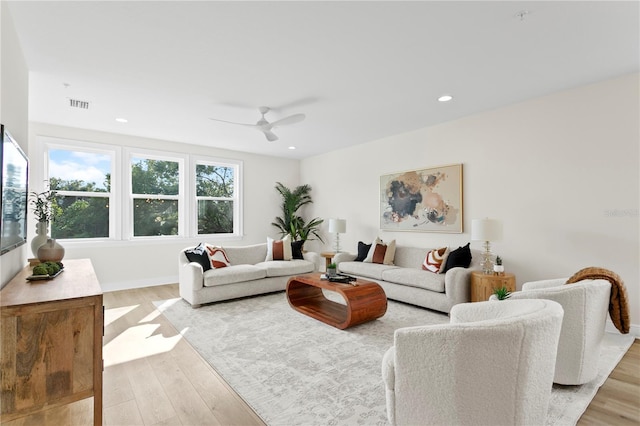 living room featuring light wood-type flooring and ceiling fan