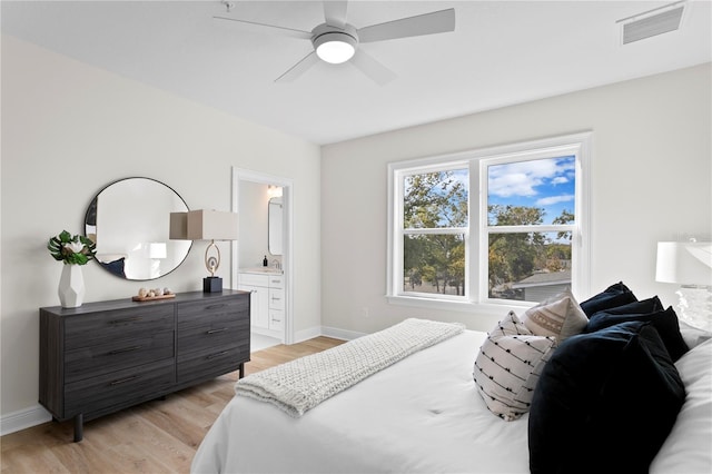 bedroom with connected bathroom, ceiling fan, and light hardwood / wood-style floors