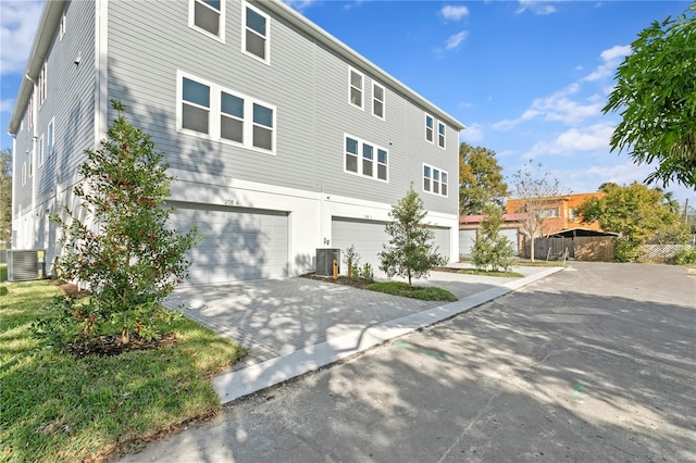 view of front of house featuring cooling unit and a garage