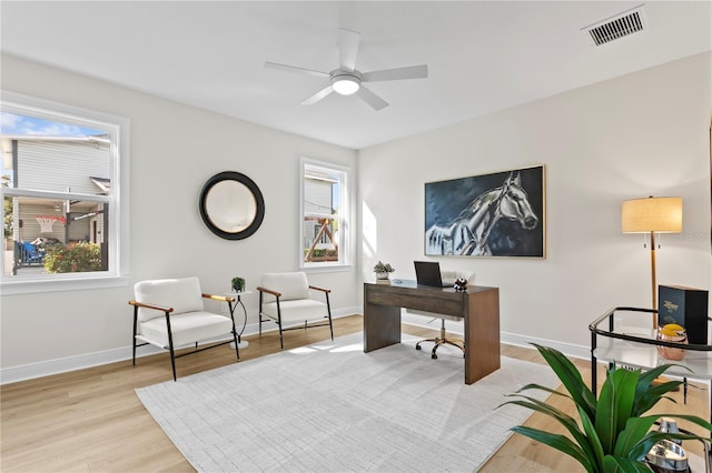 office area with ceiling fan, a wealth of natural light, and light hardwood / wood-style flooring