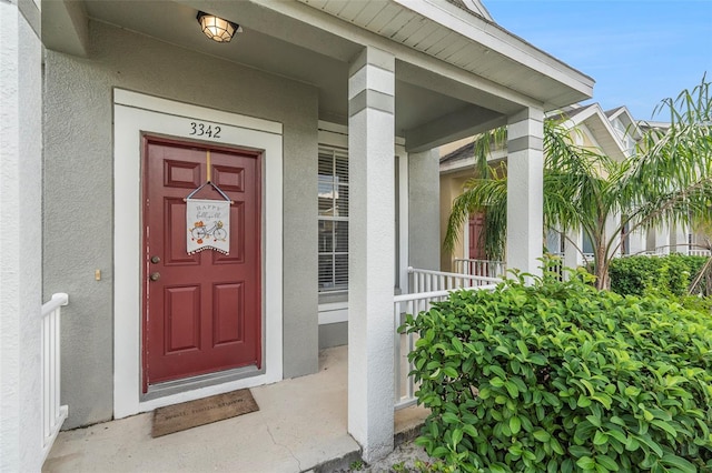 property entrance with covered porch