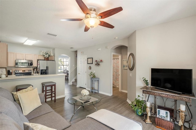 living room featuring dark hardwood / wood-style floors and ceiling fan