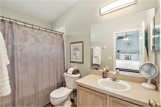 bathroom featuring vanity, lofted ceiling, toilet, and ceiling fan