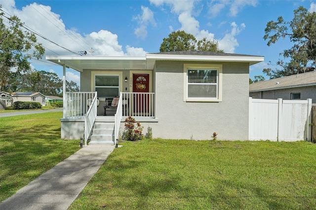 bungalow-style house with covered porch and a front yard