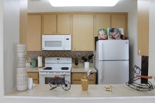 kitchen with white appliances and light brown cabinetry