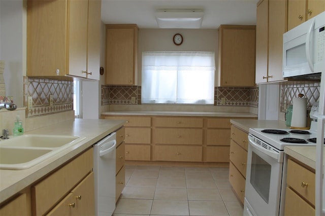 kitchen with decorative backsplash, light brown cabinets, white appliances, and light tile patterned floors