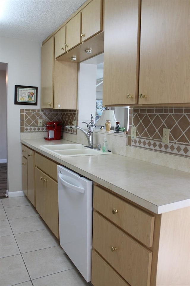 4460 95th Ave N Unit 1, Pinellas Park, FL 33782 - kitchen with light countertops, a sink, backsplash, white dishwasher, and light brown cabinets