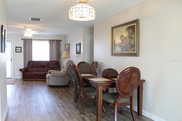 dining room with wood-type flooring and ceiling fan