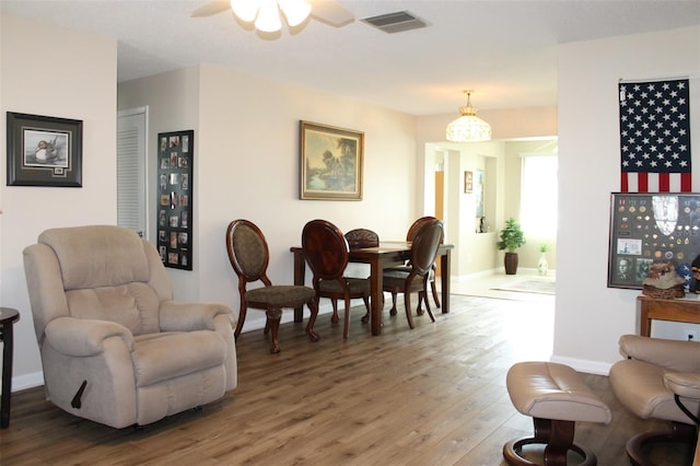 sitting room with wood-type flooring and ceiling fan