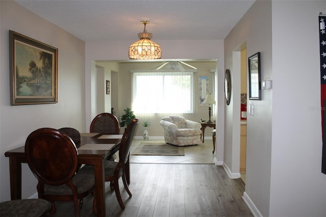 4460 95th Ave N Unit 1, Pinellas Park, FL 33782 - dining space with wood finished floors, a ceiling fan, and baseboards