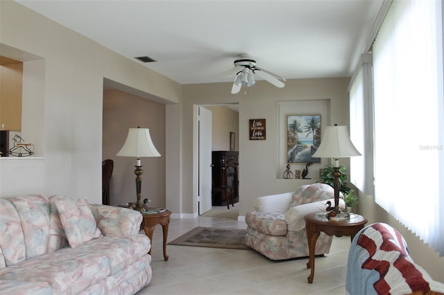 living room featuring light tile patterned floors and ceiling fan