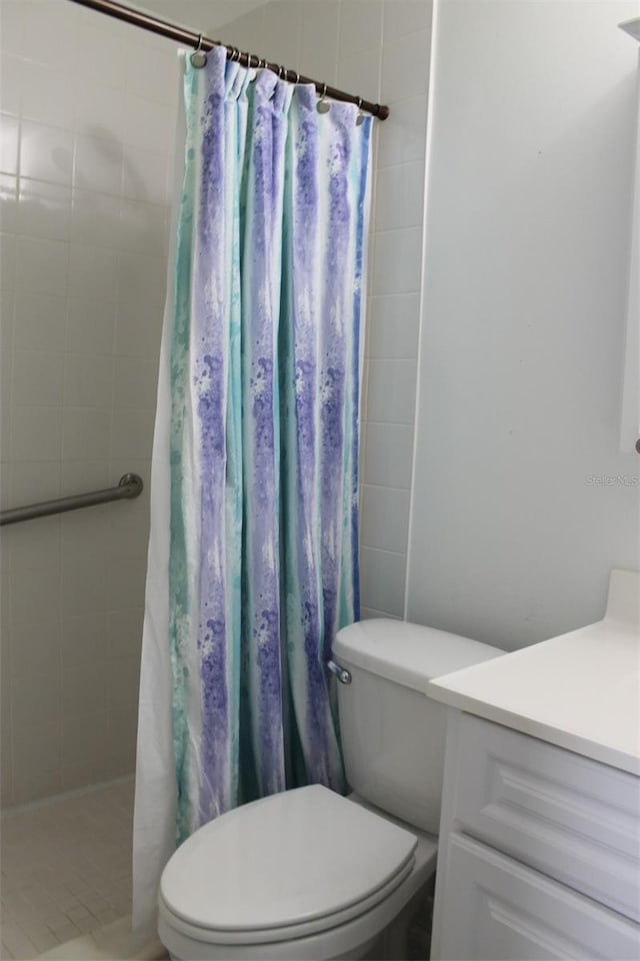 bathroom with vanity, a shower with shower curtain, toilet, and tile patterned flooring