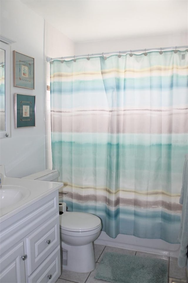 full bathroom featuring vanity, shower / bathtub combination with curtain, toilet, and tile patterned floors