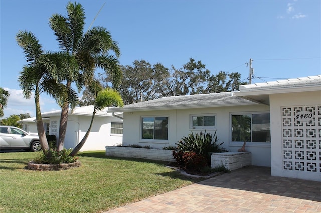 4460 95th Ave N Unit 1, Pinellas Park, FL 33782 - exterior space featuring stucco siding and a yard